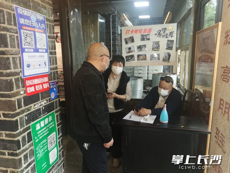 防控人員對白沙井社區(qū)商家進行排查,。