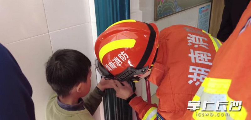 男童手指被卡鎖眼，消防員實(shí)施救援,。長沙晚報(bào)通訊員 劉姿 供圖