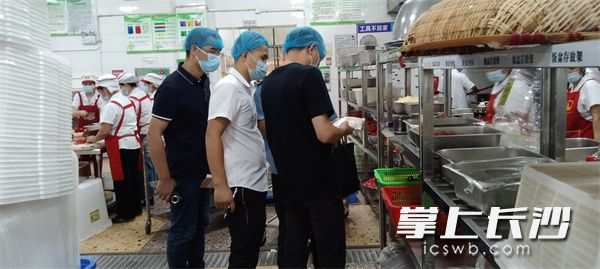 工作人員對食堂食品安全進行檢查,。