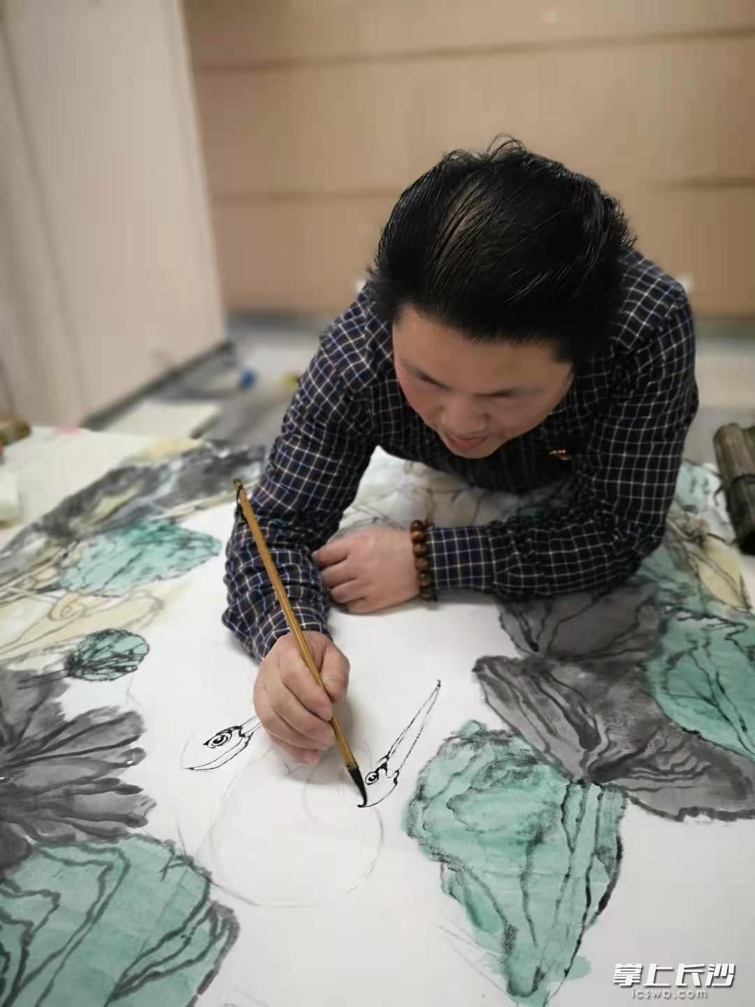 長(zhǎng)沙晚報(bào)資深美編,、青年畫家吳志立正在創(chuàng)作名為《家園》的國(guó)畫,。長(zhǎng)沙晚報(bào)全媒體記者 楊蔚然 攝